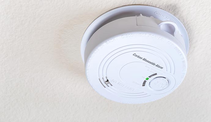 Ceiling-mounted carbon monoxide detector installed in a room for safety against gas leaks