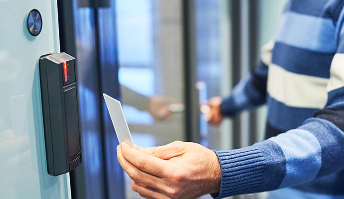 Person using access card to unlock door