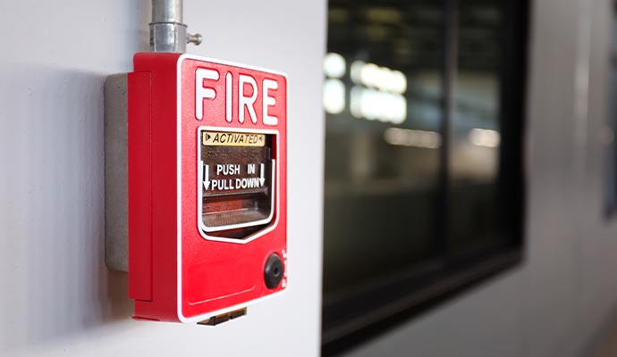 a red fire alarm activation unit mounted on the wall