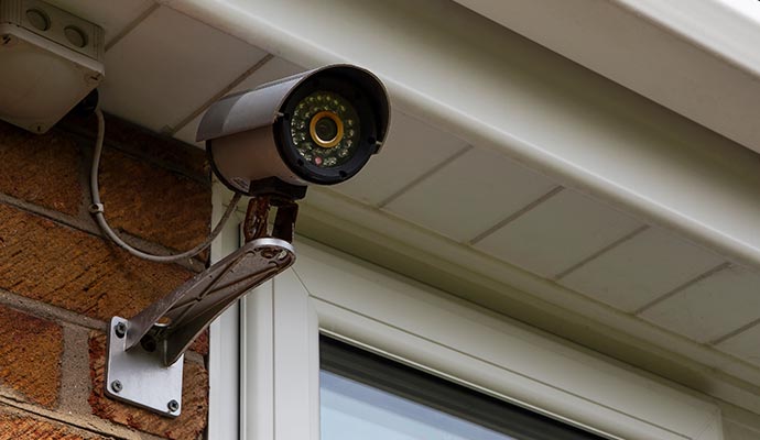 A Security camera mounted on brick wall