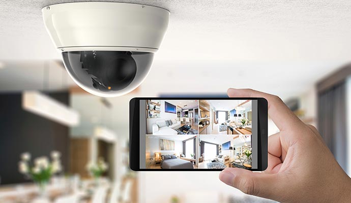 A person using their phone to monitor different cameras inside their home