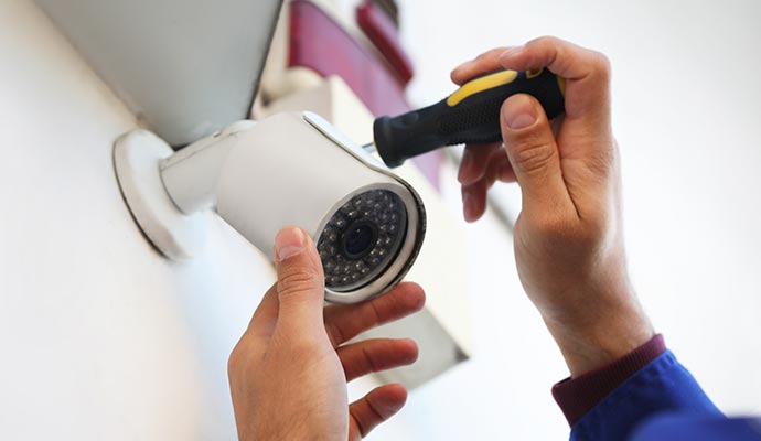 Technicians installing CCTV with screwdriver