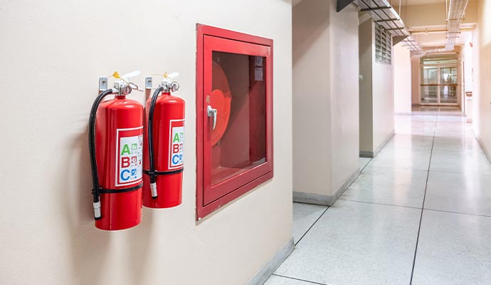 Installed fire extinguisher and fire hose cabinet in office space