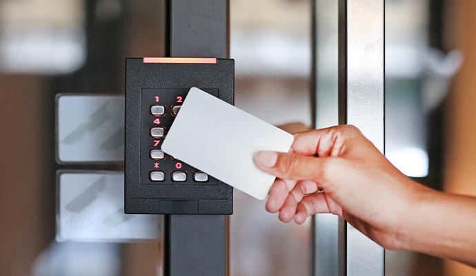 A person using a
            keycard to access a door