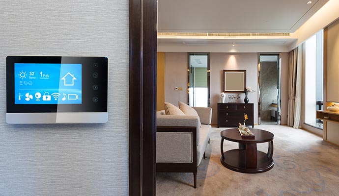 A smart home control panel on the wall in a modern living room 