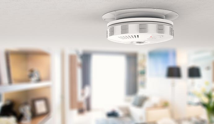 smoke detector installed on a ceiling for fire safety